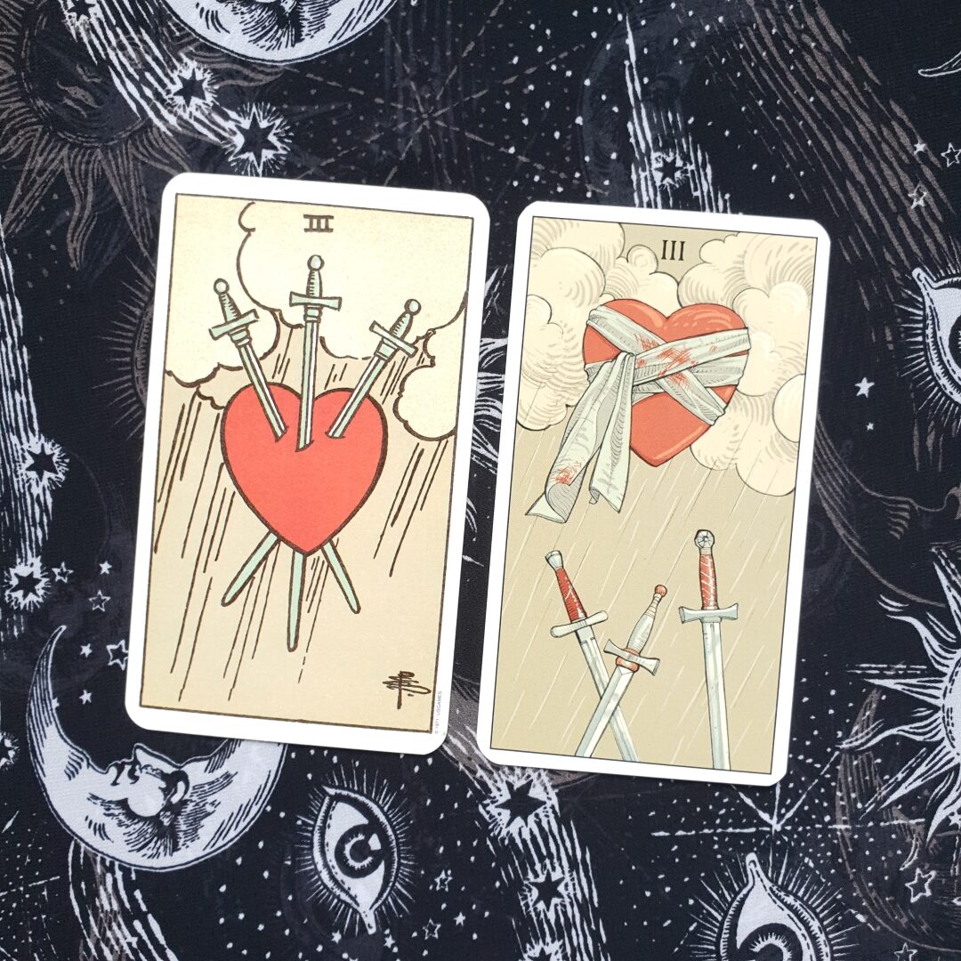 A photo of the Three of Swords card from the Original Rider Waite Smith Tarot and the After Tarot