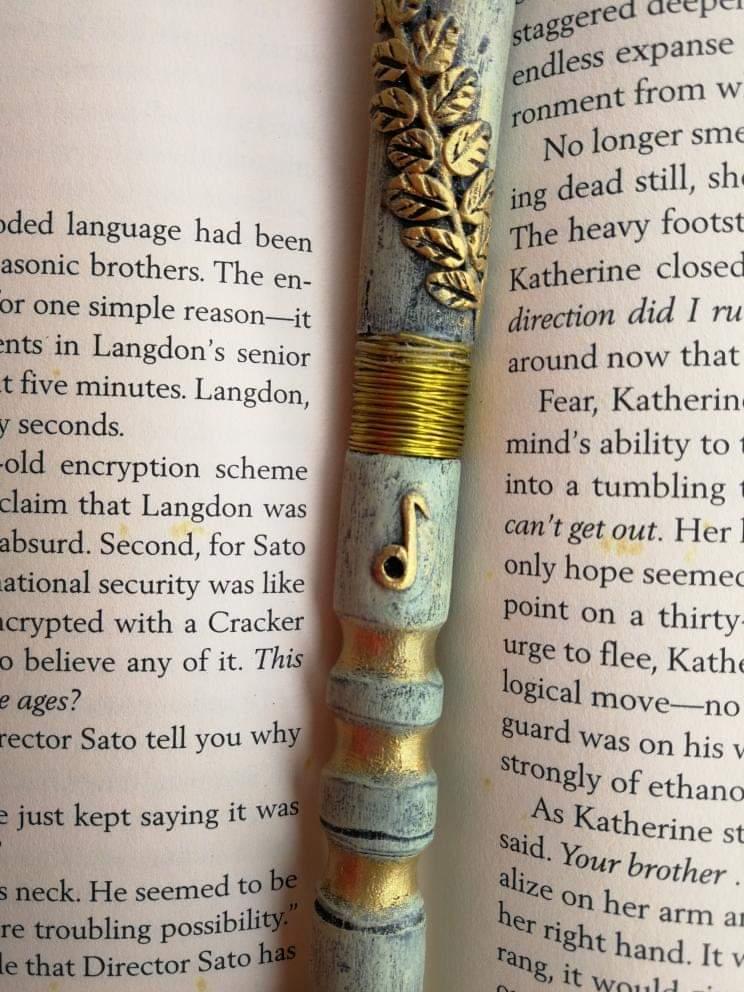 Apollo-themed wand with laurel leaves and musical note