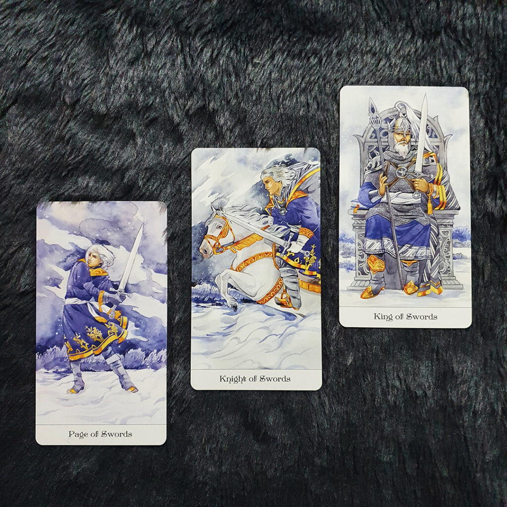 A photo of the Page, Knight, and King of Swords in Mila Losenko's Tarot of the Golden Wheel
