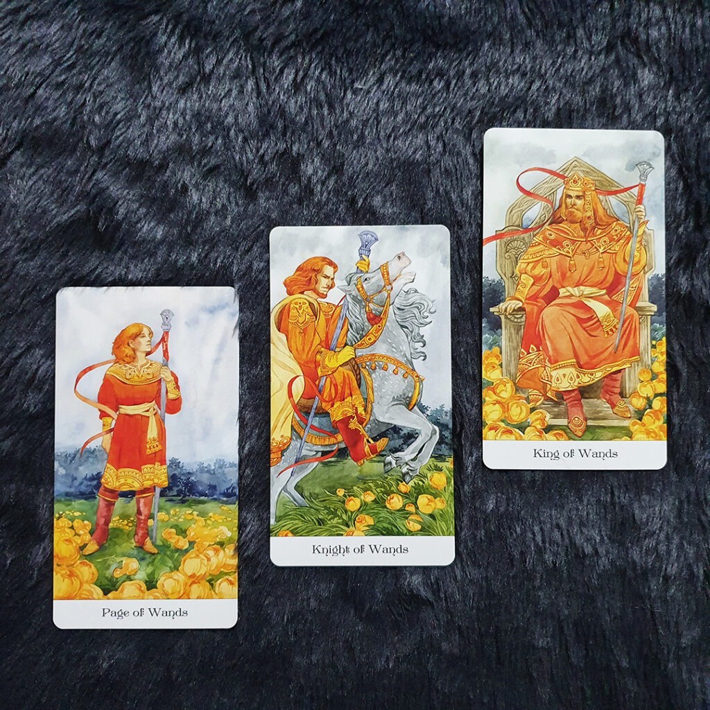A photo of the Page, Knight, and King of Wands in Mila Losenko's Tarot of the Golden Wheel