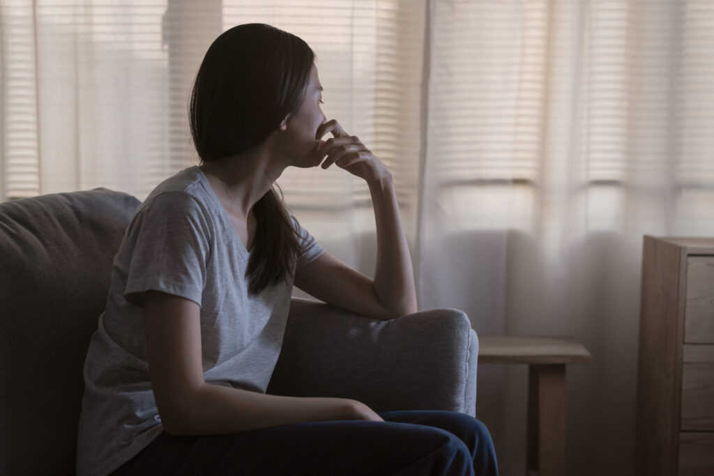 photo of woman looking sad and lonely 