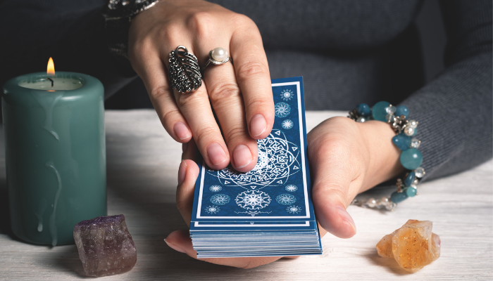 tarot reader holding a blue tarot deck
