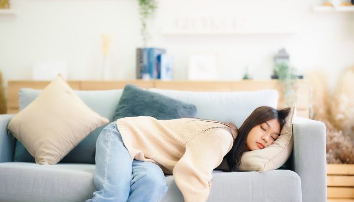 girl with low energy sleeping on a couch